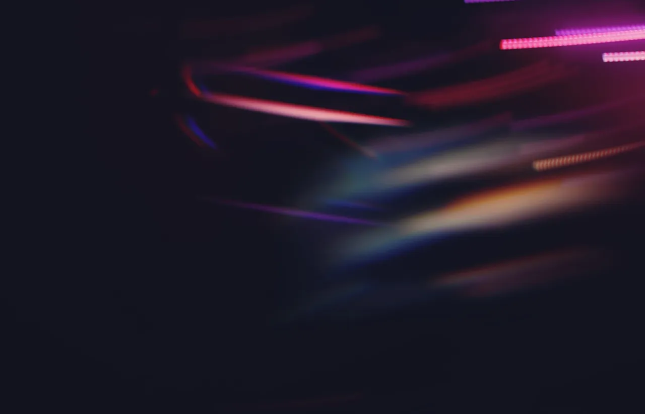 Abstract streaks of coloured light on a dark background, suggesting two parallel development paths