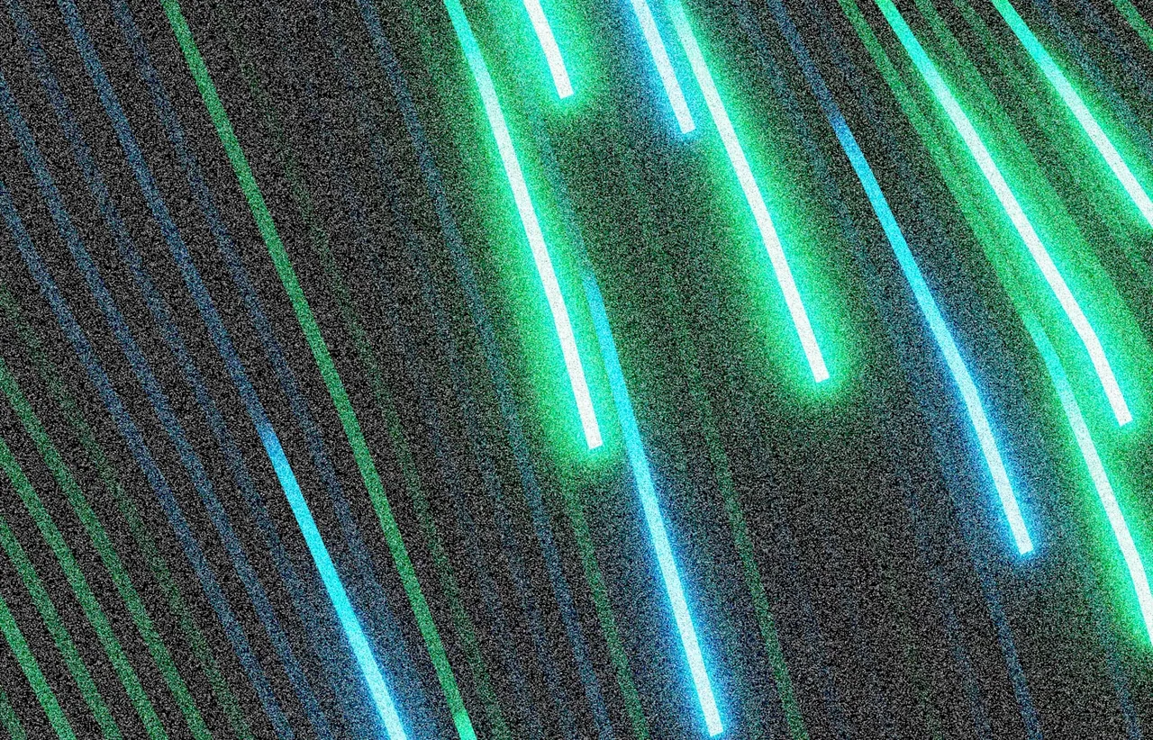 Abstract streaks of blue and green neon light, suggesting diagnostic signals in a running system