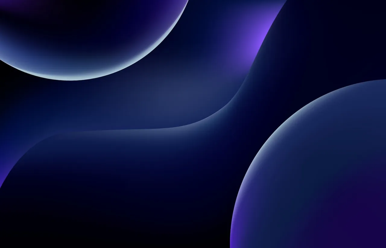 A deep blue and violet abstract expanse of soft nebula-like swirls and haze against near-black space