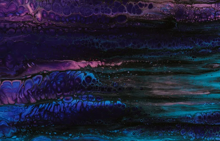 Layered purple and blue wave forms folding over one another against a black background