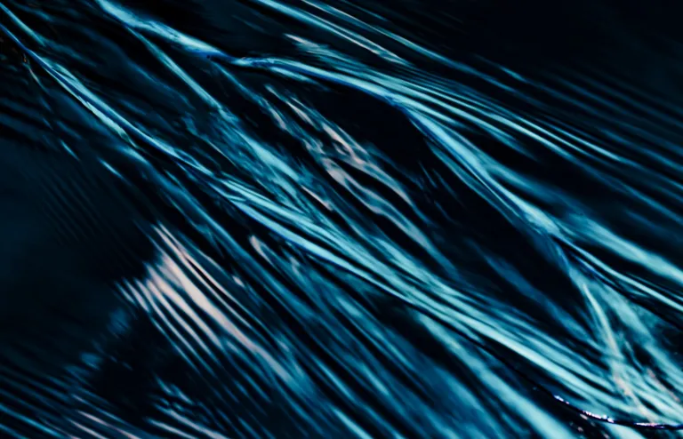 Abstract blue streaks running in parallel across a dark field, suggesting continuous signal